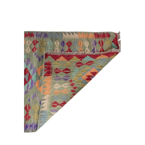 574 - A CONTEMPORARY ANATOLIAN STYLE KILIM RUNNER woven in colours with geometric pole medallion and fille... 