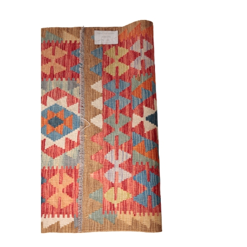 575 - A CONTEMPORARY ANATOLIAN STYLE KILIM RUNNER woven in colours with lozenge pole medallion on a madder... 