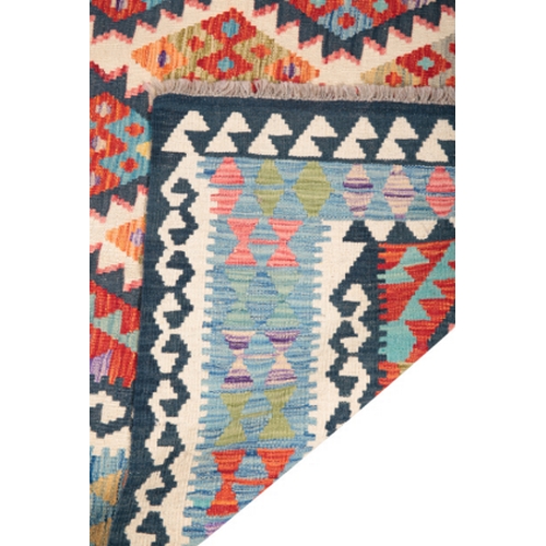 577 - A CONTEMPORARY ANATOLIAN STYLE KILIM CARPET woven in colours with endless lozenge repeat on a blue a... 