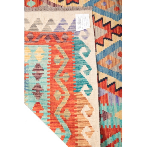 579 - A CONTEMPORARY ANATOLIAN STYLE KILIM CARPET woven in pale blue, fawn and other colours with endless ... 