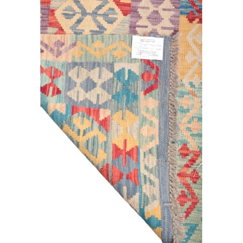 585 - A CONTEMPORARY ANATOLIAN STYLE KILIM RUNNER woven in colours with central cruciform pole medallion a... 