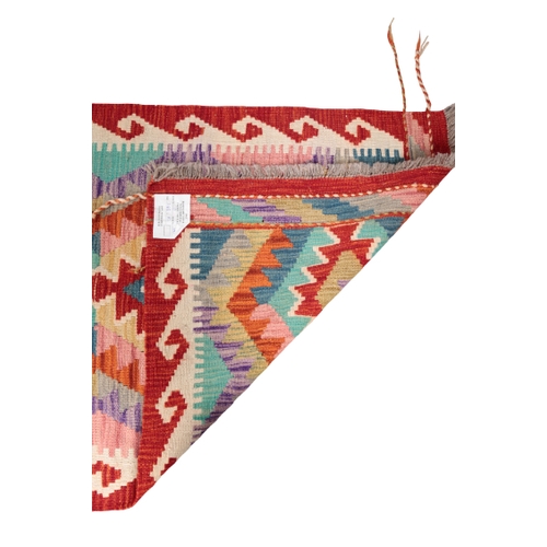 586 - A CONTEMPORARY ANATOLIAN STYLE KILIM RUNNER woven in primary colours with geometric lozenge pole med... 