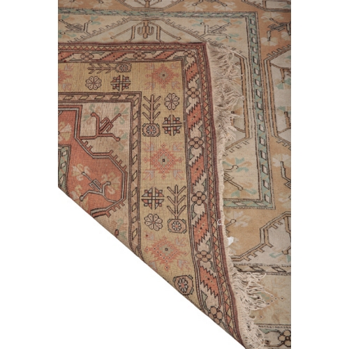 596 - AN ANATOLIAN RUG woven in muted colours with square medallion and geometric motifs within concentric... 