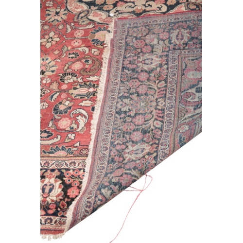 597 - AN ANTIQUE TABRIZ CARPET woven in blue, cream and muted colours with double headed medallion, spandr... 