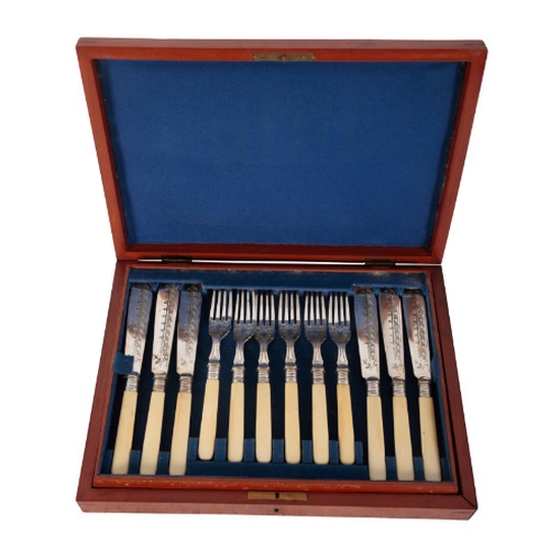 69 - A LATE VICTORIAN SILVER PLATED FISH SERVICE with engraved blades and ivorine handles, comprising six... 