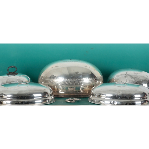 70 - A SET OF THREE 19TH CENTURY SILVER PLATED GRADUATED OVAL CLOCHES with leaf mounts and lobed bodies, ... 