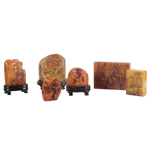 13 - A GROUP OF SIX CHINESE CARVED SOAPSTONE SEALS four of which are figured as mountainous landscapes, t... 