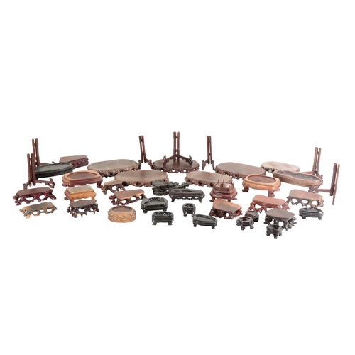 2 - A COLLECTION OF CHINESE WOODEN STANDS the largest c.22cm wide, the smallest c.5.5cm wide (a lot -app... 