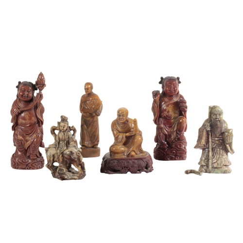 21 - A GROUP OF SIX CHINESE SOAPSTONE FIGURES including a large seal figured as a woman holding a lotus f... 