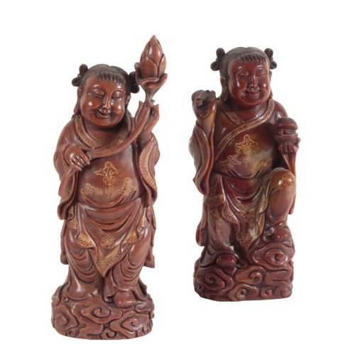 21 - A GROUP OF SIX CHINESE SOAPSTONE FIGURES including a large seal figured as a woman holding a lotus f... 