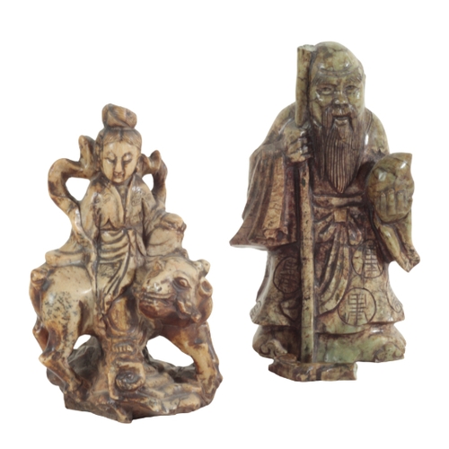 21 - A GROUP OF SIX CHINESE SOAPSTONE FIGURES including a large seal figured as a woman holding a lotus f... 