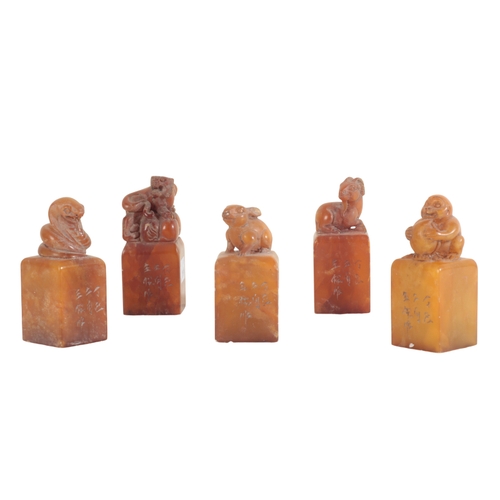 38 - A COLLECTION OF TWENTY CHINESE SOAPSTONE SEALS all of block form with figural finials, the tallest 1... 
