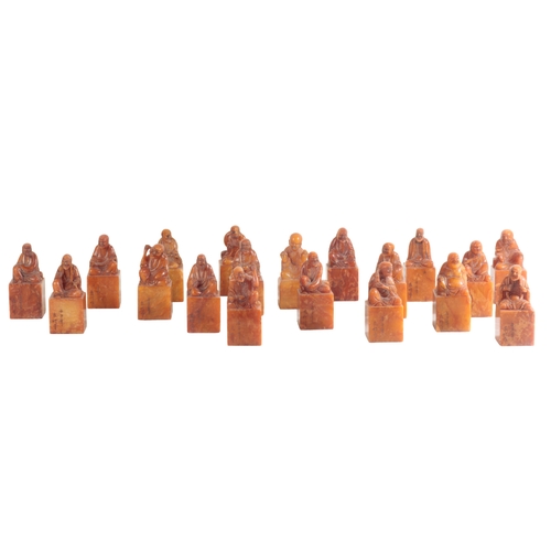 39 - A GROUP OF NINETEEN CHINESE SOAPSTONE SEALS all of block form with figural finials, all measure c.12... 