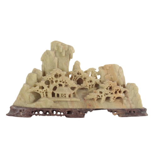 42 - FOUR CHINESE SOAPSTONE LANDSCAPES each carved in relief to depict pagodas in mountainous surrounding... 