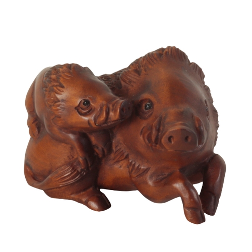 73 - TWO JAPANESE CARVED WOOD NETSUKE one example, in the form of a starving wolf, signed to the base, me... 