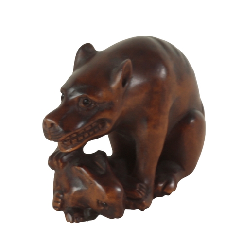 73 - TWO JAPANESE CARVED WOOD NETSUKE one example, in the form of a starving wolf, signed to the base, me... 