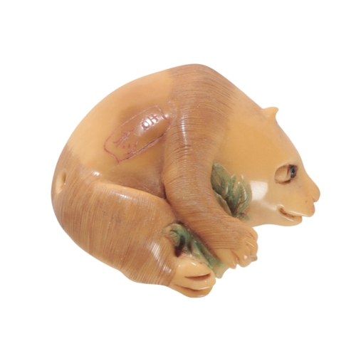 78 - TWO JAPANESE NETSUKE including a carved tagua nut example, in the form of a panda, 3.5cm high, and a... 