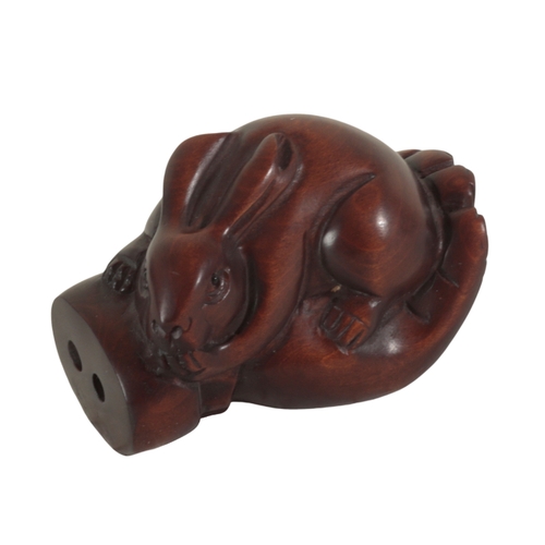 83 - TWO JAPANESE CARVED WOOD NETSUKE one example modelled as a goat, signed to the base of a foot, 4cm h... 