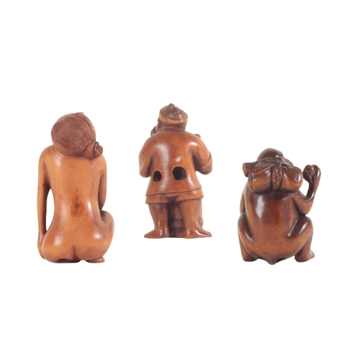 94 - A GROUP OF THREE JAPANESE CARVED WOOD NETSUKE including an example figured as a monkey eating fruit,... 