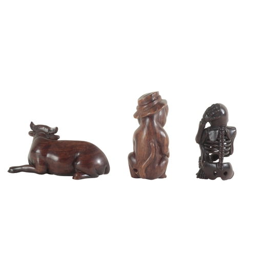 97 - THREE JAPANESE NETSUKE including an example modelled as a water buffalo, signed 6cm long, a skeleton... 