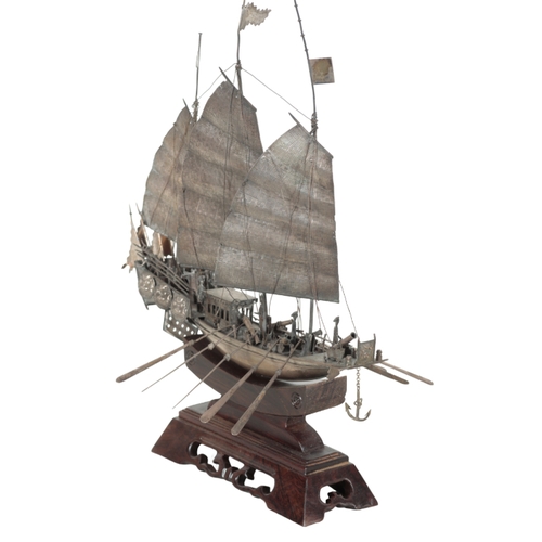 126 - A CHINESE WHITE METAL MODEL OF A THREE MASTED JUNK on carved hardwood plinth, 38.5cm high, marked to... 