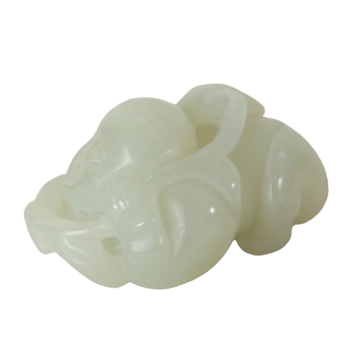 127 - A CHINESE PALE CELADON JADE CARVING OF A BOY lying on his front, holding a vine to his back, 5.5cm l... 