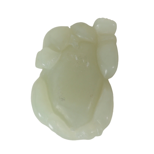 127 - A CHINESE PALE CELADON JADE CARVING OF A BOY lying on his front, holding a vine to his back, 5.5cm l... 