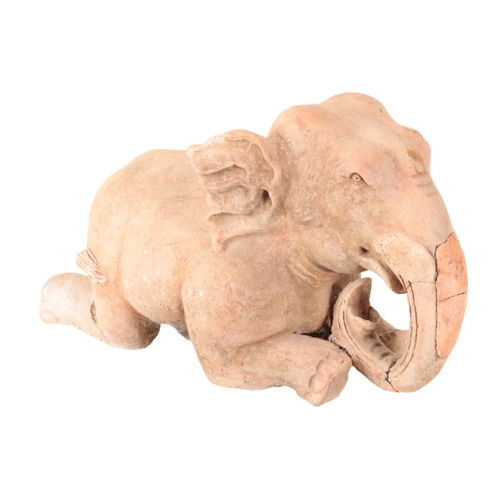 162 - AN INDIAN TERRACOTTA ELEPHANT late 19th or early 20th century, modelled kneeling, 33cm high x 55cm l... 