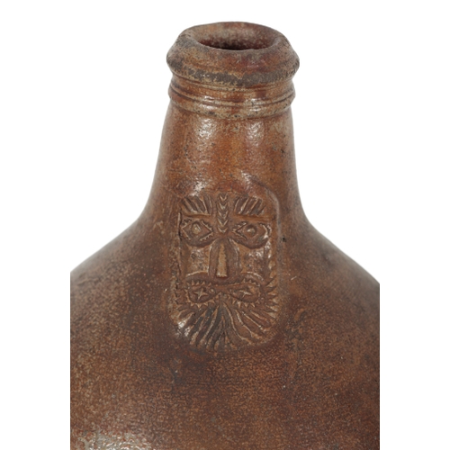 171 - A 17TH CENTURY BROWN STONEWARE BELLARMINE FLAGON with face mask and plain body, 35cm high