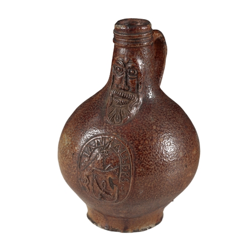 173 - A 17TH CENTURY DARK BROWN STONEWARE BELLARMINE FLAGON with face mask and cartouche worded âIan All... 