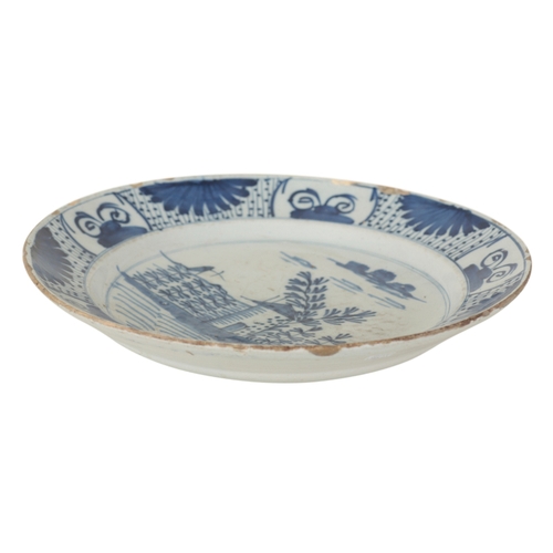 179 - A DUTCH DELFT BLUE AND WHITE CHARGER late 18th or early 19th century, decorated with a house amongst... 