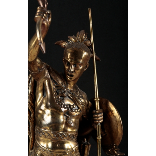 184 - A GILT METAL TABLE LAMP modelled as a fighting warrior, standing on a circular base, 74cm high