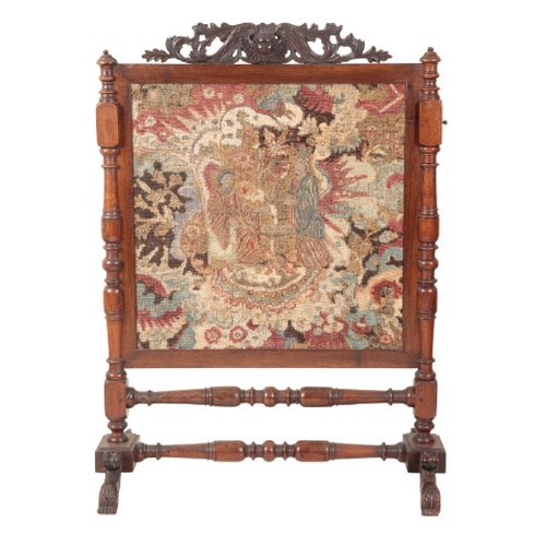 275 - A VICTORIAN ROSEWOOD FIRESCREEN the leaf carved cresting with Cupid, inset with a 17th Century needl... 