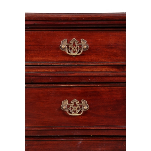 281 - A GEORGE III STYLE MAHOGANY KNEEHOLE DESK with reeded and rounded front corners, the top inset with ... 