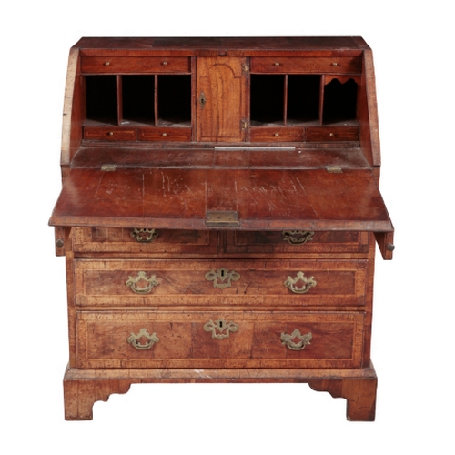 283 - A GEORGE I WALNUT BUREAU early 18th century, the fall front opening to drawers and pigeonholes, a se... 