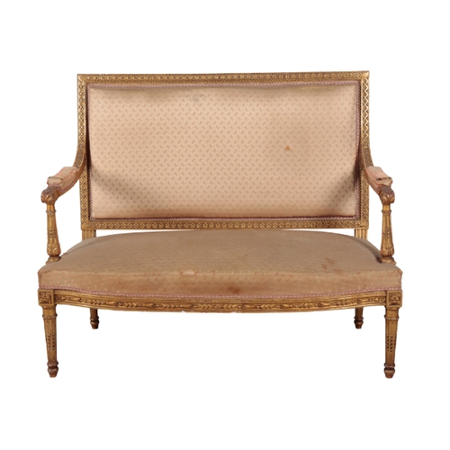 292 - A LOUIS XVI STYLE GILWOOD SETTEE with silk covers, the square back over a bowfront seat, on tapering... 