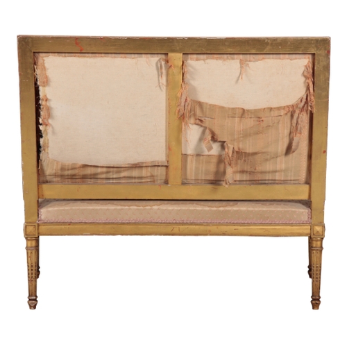 292 - A LOUIS XVI STYLE GILWOOD SETTEE with silk covers, the square back over a bowfront seat, on tapering... 