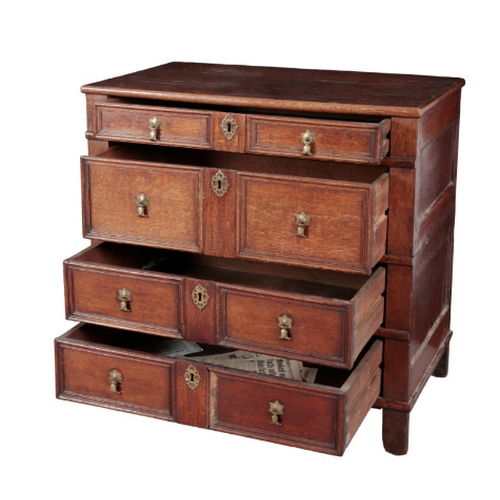 299 - A CHARLES II STYLE OAK CHEST OF DRAWERS in two sections, both incorporating geometric panelled long ... 