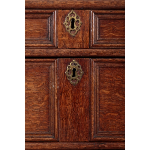 299 - A CHARLES II STYLE OAK CHEST OF DRAWERS in two sections, both incorporating geometric panelled long ... 