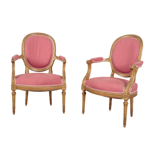 309 - A LOUIS XVI STYLE GILTWOOD THREE PIECE SUITE 20th century, with cotton covers, the oval backs with c... 