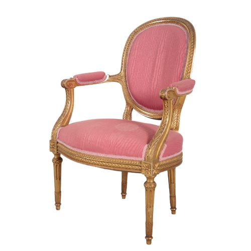 309 - A LOUIS XVI STYLE GILTWOOD THREE PIECE SUITE 20th century, with cotton covers, the oval backs with c... 