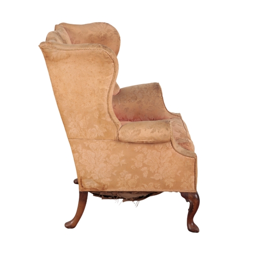 314 - A GEORGE I STYLE MAHOGANY WING ARMCHAIR with shaped back, outscrolled arms, moulded cabriole front l... 