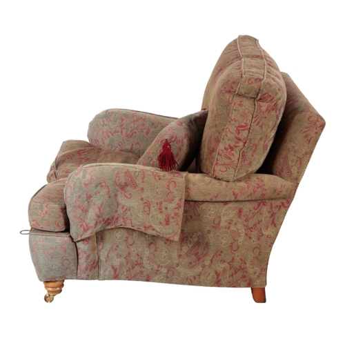 325 - A HOWARD STYLE âCOUNTRY HOUSEâ ARMCHAIR upholstered in red and green floral, urn and bird fabric... 