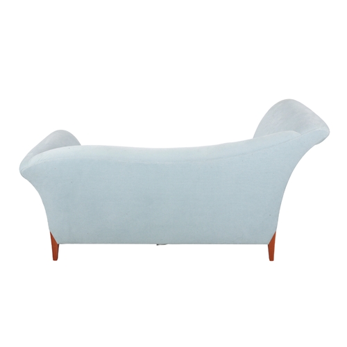 326 - A CONTEMPORARY CHAISE LONGUE upholstered in pale blue fabric, with scrolled head and foot, on square... 