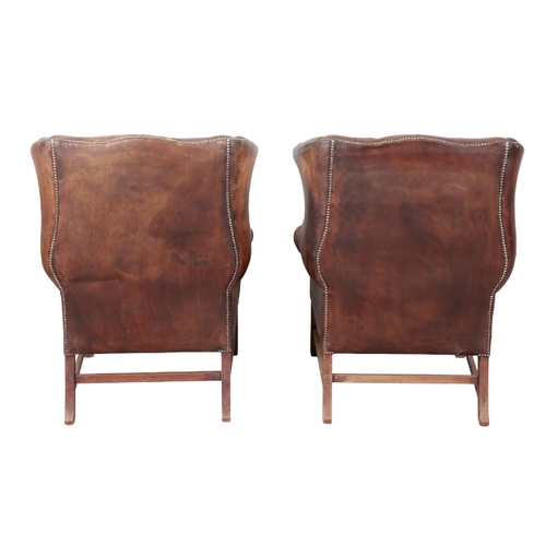 331 - A PAIR OF GEORGE III STYLE MAHOGANY WING CHAIRS 20th century, upholstered in buttoned dark brown lea... 