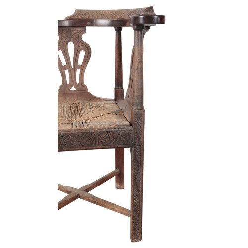 338 - A GEORGE III MAHOGANY CORNER ARMCHAIR later carved throughout with leaves and rosettes, with horse s... 