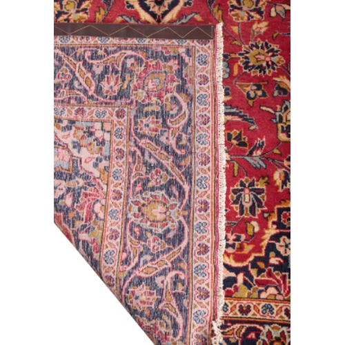 379 - A KASHAN RUG 20th Century, woven shades of blue, fawn and other colours with floral filled oval doub... 