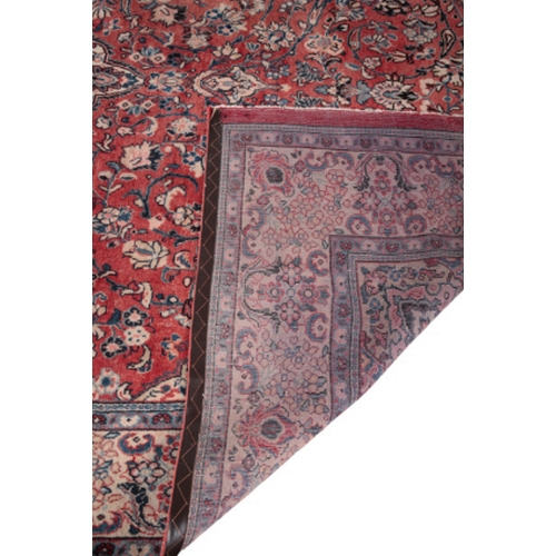 386 - A MESHAD CARPET woven in blue and fawn with classical Persian medallion, spandrels and scrolled flor... 