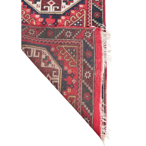 387 - A TURKISH RUNNER OF USHAK STYLE woven in gold, blue, brown and off white with five guls and filler m... 