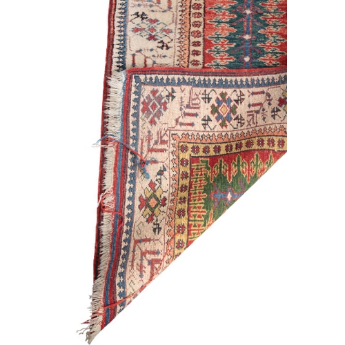 389 - A SERAB STYLE RUNNER woven in blue and red with central pole medallion on a green ground (faded to b... 